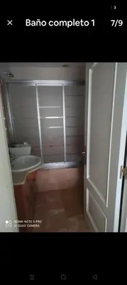 a bathroom with a toilet and a sink and a door at Precioso piso en Ribadavia in Ribadavia