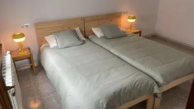 two twin beds in a bedroom with two lamps at Piso con terraza y garaje a un Paso de la Playa de Tapia in Tapia de Casariego
