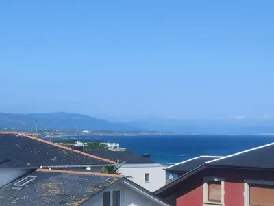 a view of the ocean from the roofs of buildings at Piso con terraza y garaje a un Paso de la Playa de Tapia in Tapia de Casariego