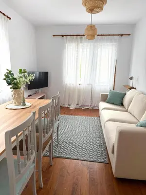 a living room with a couch and a table at Apartamento a Un Paso de la Playa de Tapia in Tapia de Casariego