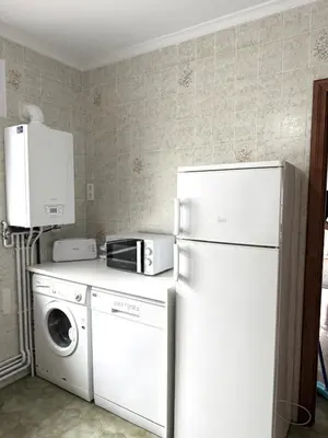a kitchen with a refrigerator and a washer and dryer at Apartamento a Un Paso de la Playa de Tapia in Tapia de Casariego