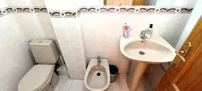 a small bathroom with a toilet and a sink at EnFOZ 1ª Línea de Playa II in Foz