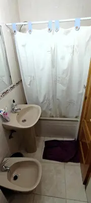 a bathroom with a sink and a shower curtain at EnFOZ 1ª Línea de Playa II in Foz