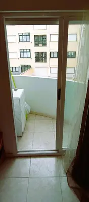 an open door to a balcony with a view of a building at EnFOZ 1ª Línea de Playa II in Foz