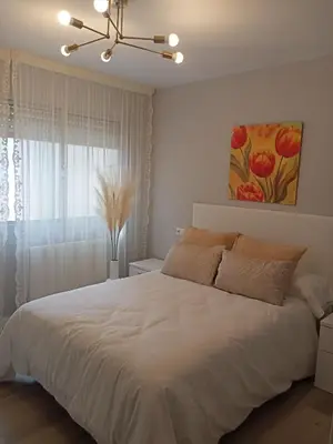a bedroom with a large white bed and a window at Luz de Guía in Burela de Cabo