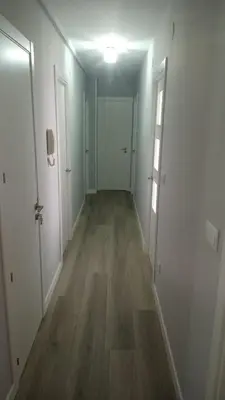 an empty room with a hallway with wood floors at Luz de Guía in Burela de Cabo