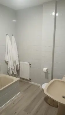 a bathroom with a tub and a toilet and a sink at Luz de Guía in Burela de Cabo