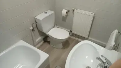 a bathroom with a white toilet and a sink at Luz de Guía in Burela de Cabo