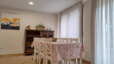 a dining room with a table and chairs at Vivienda de Uso Turístico Los Castaños in San Román de Sanabria