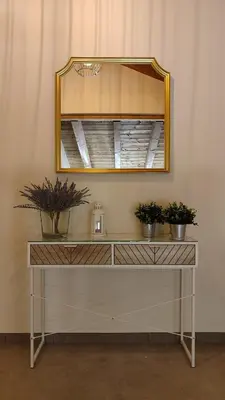 a dressing table with potted plants on it with a mirror at Vivienda de Uso Turístico Los Castaños in San Román de Sanabria