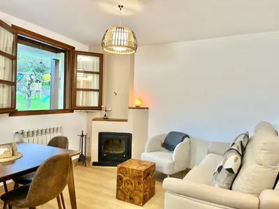 a living room with a couch and a table and a fireplace at Fuentes del Narcea apartamentos rurales in Cangas del Narcea