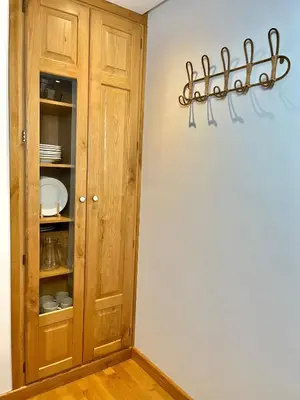 a room with a cabinet with plates on a wall at Fuentes del Narcea apartamentos rurales in Cangas del Narcea