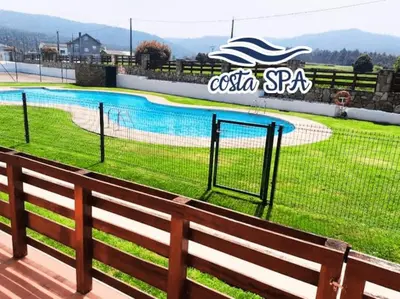 a fence in front of a swimming pool at Costa SPA Piscinas de lujo - Playa las Catedrales in Barreiros