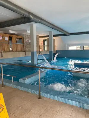 a large swimming pool with a water fountain at Costa SPA Piscinas de lujo - Playa las Catedrales in Barreiros