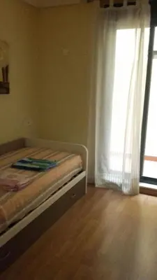 a bedroom with a bed and a large window at Costa SPA Piscinas de lujo - Playa las Catedrales in Barreiros