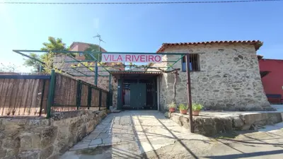 a building with a sign that reads villa rivero at Vila Riveiro in Vilamelle