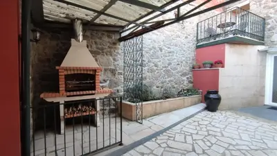 a patio with an outdoor oven in a building at Vila Riveiro in Vilamelle