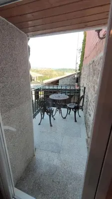a view of a balcony with a table and benches at Vila Riveiro in Vilamelle