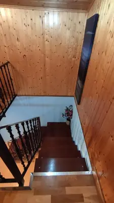 a set of stairs in a room with wooden walls at Vila Riveiro in Vilamelle