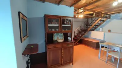 a room with a wooden cabinet and a staircase at Vila Riveiro in Vilamelle
