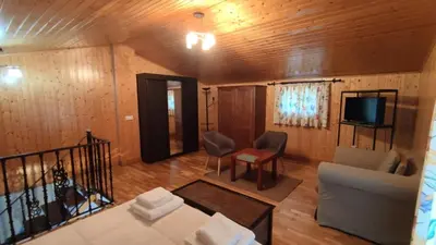 a living room with a couch and a tv at Vila Riveiro in Vilamelle