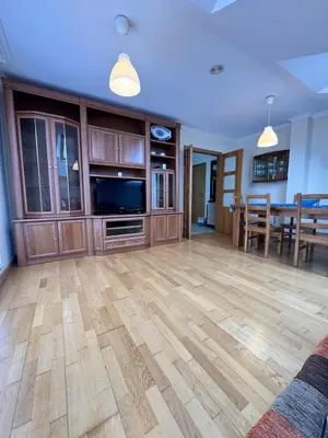 a living room with a wooden floor and a dining room at Apartamento Montemar in San Cosme de Barreiros
