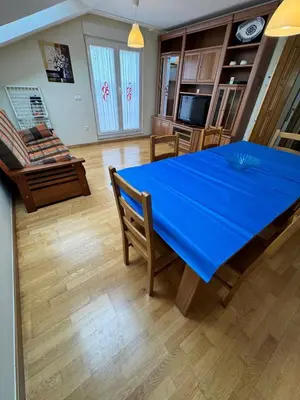 a dining room with a blue table and chairs at Apartamento Montemar in San Cosme de Barreiros