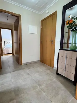 a room with a door and a vase of flowers at Apartamento Montemar in San Cosme de Barreiros