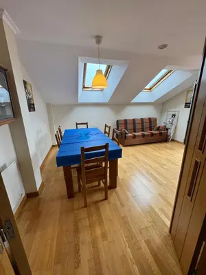 a dining room with a blue table and a living room at Apartamento Montemar in San Cosme de Barreiros