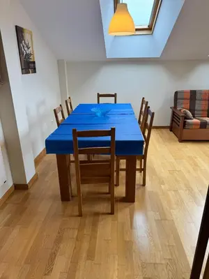 a blue table and chairs in a living room at Apartamento Montemar in San Cosme de Barreiros