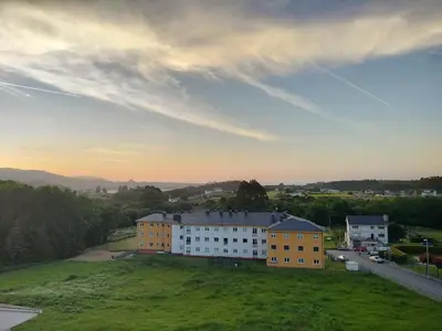 an aerial view of a building on a green field at Apartamento Montemar in San Cosme de Barreiros
