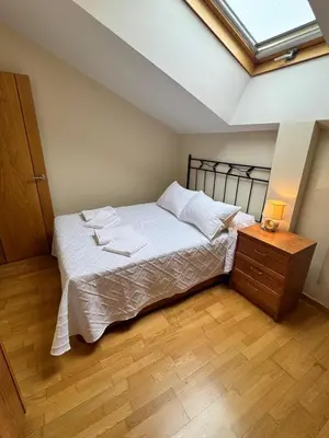 a bedroom with a bed and a wooden floor at Apartamento Montemar in San Cosme de Barreiros