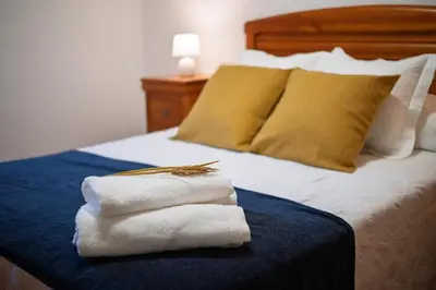 a bed with two towels on top of it at Casa Rural Antonio de Sofia in César
