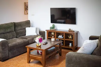 a living room with two couches and a coffee table at Casa Rural Antonio de Sofia in César