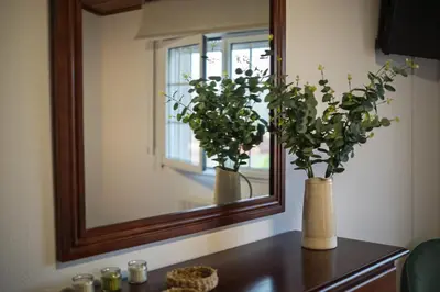 two vases sitting on a table in front of a mirror at Casa Rural Antonio de Sofia in César