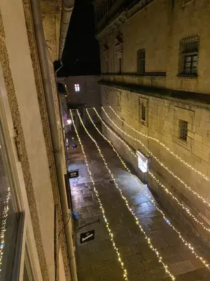 an empty street with christmas lights on a building at Pensión Residencia Fonseca in Santiago de Compostela