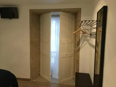 a door with a curtain in a room at Pensión Residencia Fonseca in Santiago de Compostela