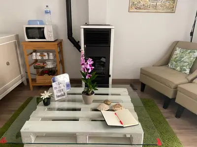 a living room with a glass table with books on it at Pensión Residencia Fonseca in Santiago de Compostela