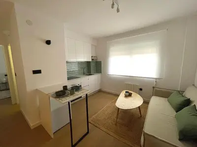 a living room with a couch and a table at Cozy and centrally located apartment in Santiago de Compostela