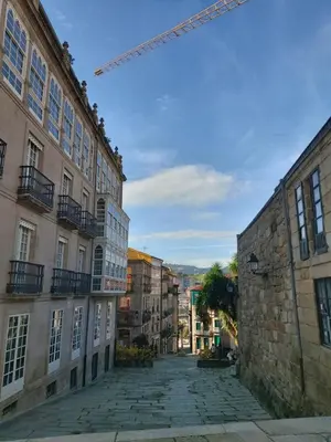 an empty street in a city with buildings at YourHouse Oasis Urbano in Ourense