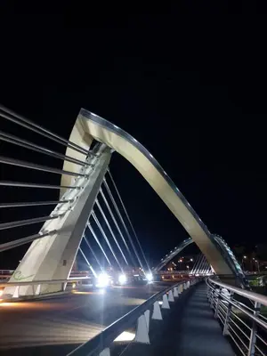 a large white bridge at night with cars at YourHouse Oasis Urbano in Ourense