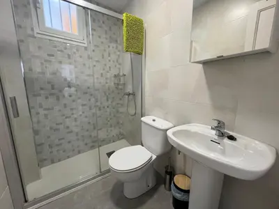 a bathroom with a toilet and a sink and a shower at YourHouse Oasis Urbano in Ourense