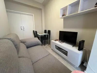 a living room with a couch and a flat screen tv at YourHouse Oasis Urbano in Ourense