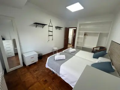 a bedroom with two beds and a desk and a ladder at Campus stellae in Arzúa