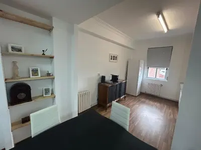 an empty living room with white walls and wooden floors at Campus stellae in Arzúa