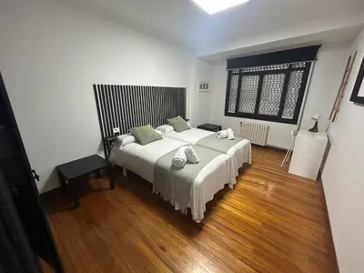 a white bathroom with a sink and a shower at Campus stellae in Arzúa