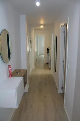 a hallway with a mirror on the wall and a hallway with a vanity at Alojamiento Doble R in Villalba