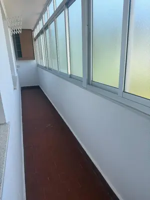 an empty hallway with windows in an office building at Apto Mirandés in Burela de Cabo