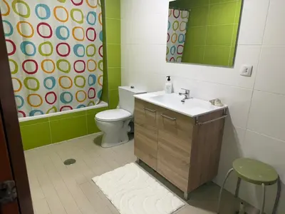 a bathroom with a toilet and a sink and a mirror at Apto Mirandés in Burela de Cabo