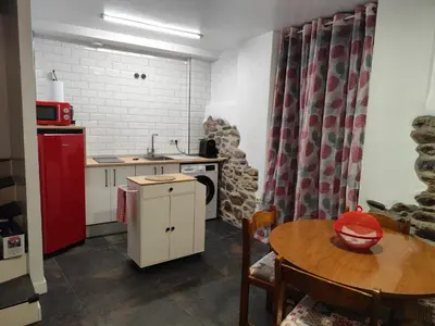 a kitchen with a table and a red refrigerator at Casa Loma Manolo in Molinaseca